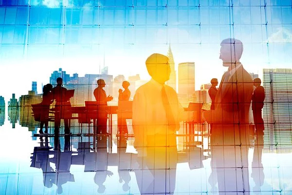 Business professionals networking and shaking hands in a modern office with city skyline reflection in glass wall