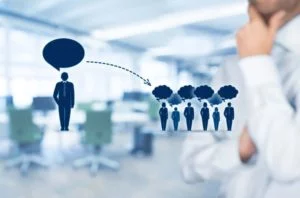 Abstract concept of communication influence showing one speaker affecting the thoughts of a group in an office setting