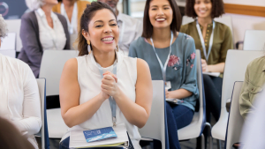 Group of diverse people smiling and applauding during a seminar or workshop