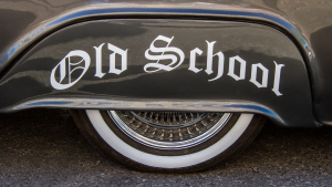Close-up of vintage car tire with whitewall and 'Old School' written on fender