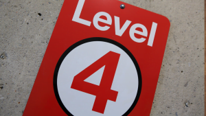Red and white sign displaying 'Level 4' on concrete wall