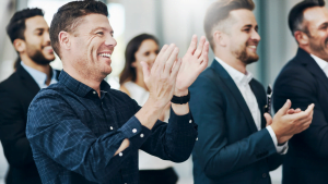 Group of business professionals applauding during corporate event
