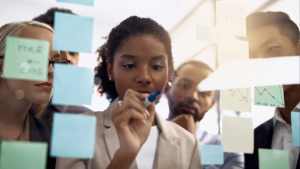 Group of diverse colleagues happily discussing work in office