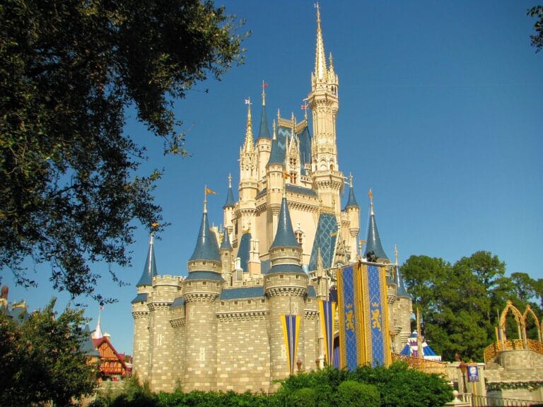 Iconic Cinderella Castle at Disney theme park under bright blue sky