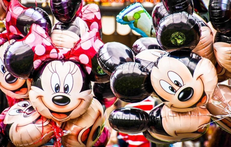 Cluster of Mickey and Minnie Mouse shaped balloons at a festive event
