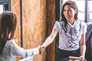Successful business people shaking hands, finishing up a meeting.