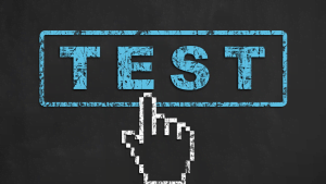 Cursor clicking on a blue 'TEST' button on a blackboard background representing online testing or quiz