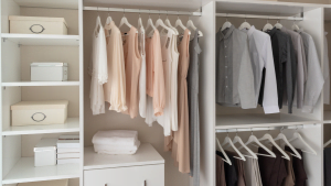 Organized wardrobe with neatly hung clothes and folded items on shelves